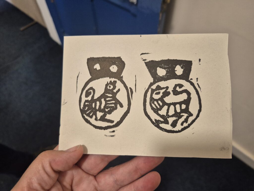 Lino prints of trader emblems created by Zoe Richardson, York Archaeology